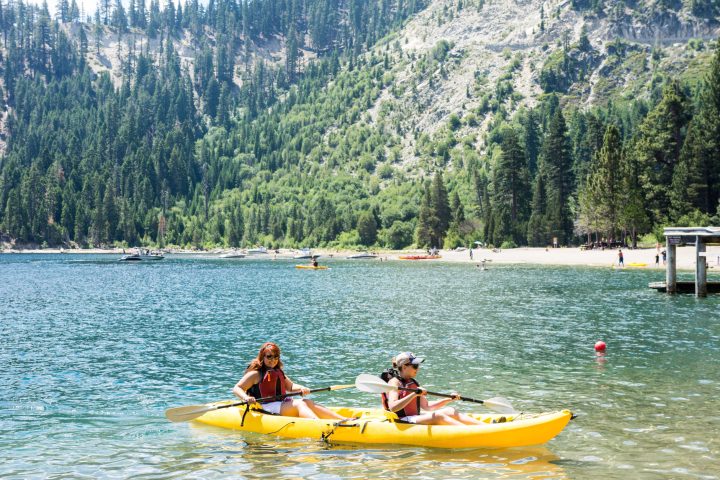 Girls on tandem kayak in emerald bay