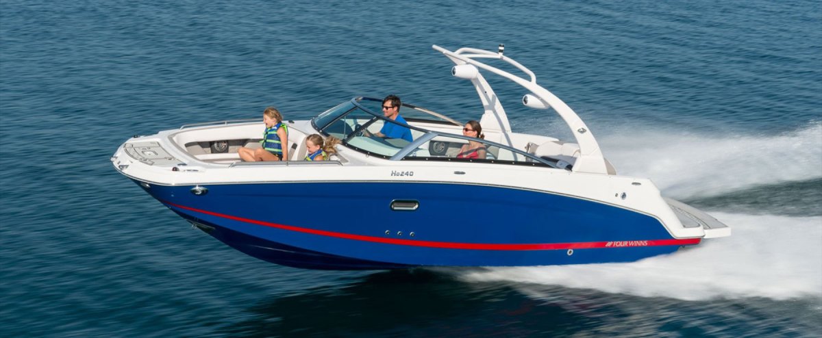 Four-Winns-HD-240-1-1 a small boat in a body of water
