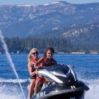 a man riding on the back of a boat in a body of water