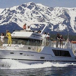 a small boat in a body of water with a mountain in the background