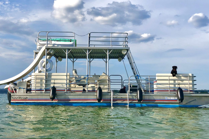 a person riding on the back of a boat in the water
