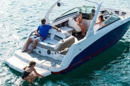 a person riding on the back of a boat in the water
