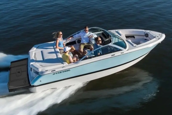 Group enjoying a ride on a speeding motorboat in open water.